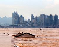 China rushes to contain floods after record rainfall