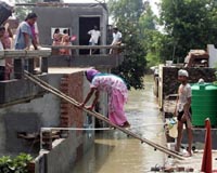 Waters in India recede, but officials warn flood danger still high