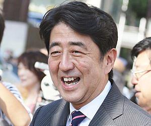Japan PM Abe visits island near disputed chain
