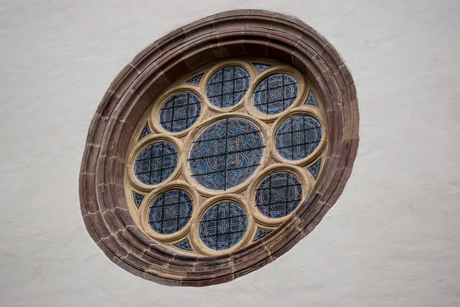We tend to picture glass as a slow-moving liquid because old cathedral windows are thicker at the bottom, but physicists have shown the sag is a manufacturing artefact of medieval glassmakers, and room-temperature glass would need timescales far longer than the age of the universe to flow